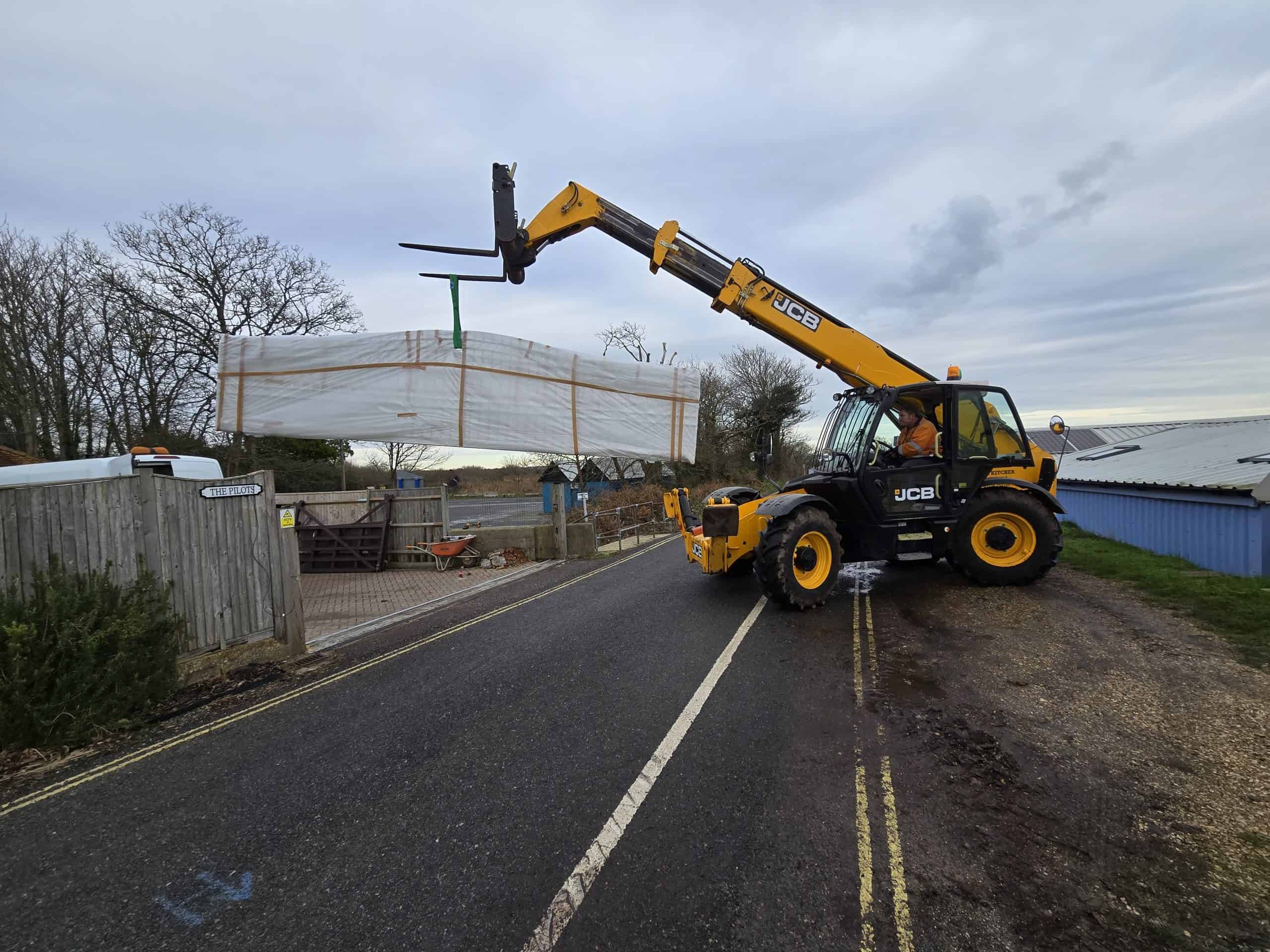 Telehandler lifting sliding gate at The Pilots Calshot installation