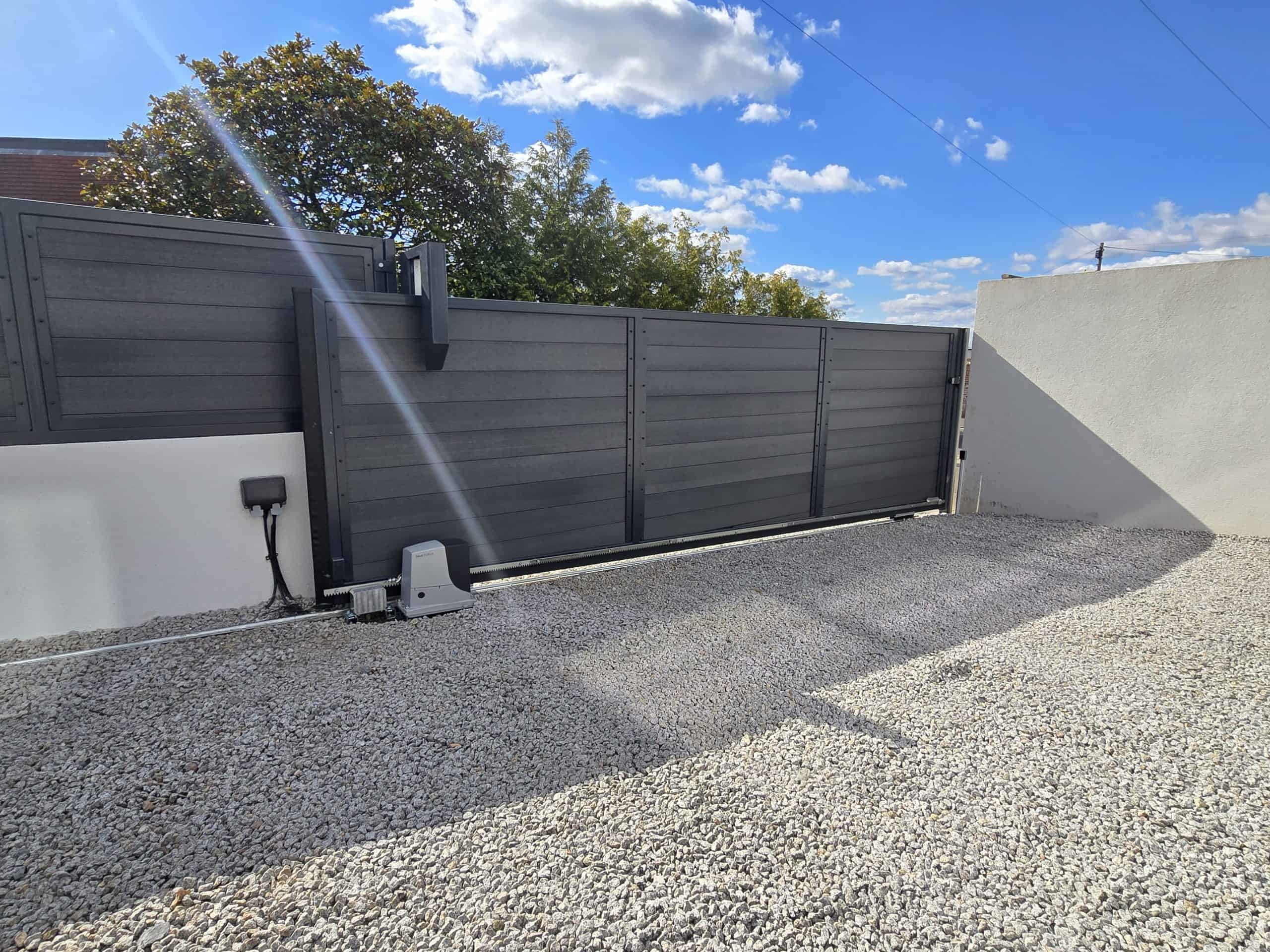Sliding gate secondary motor system for controlled descent on sloped driveway
