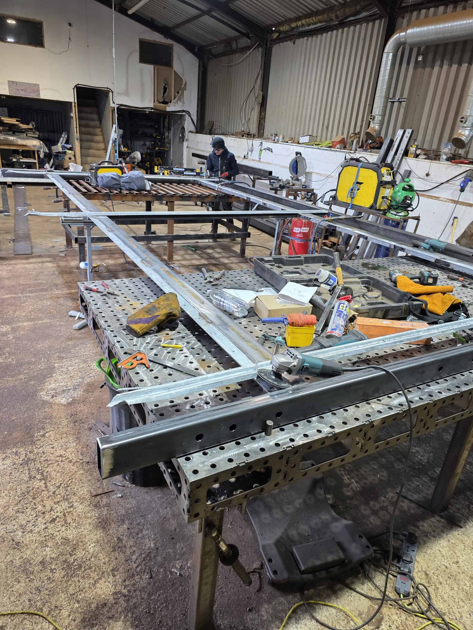Cantilever gate frame across fabrication benches